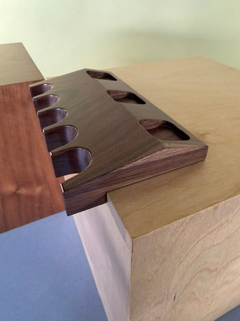 Pool Cue Claw with a dark wood where you can place five different pool sticks. 